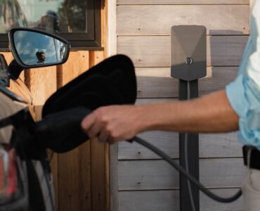 a man pumping gas into his car at a gas station